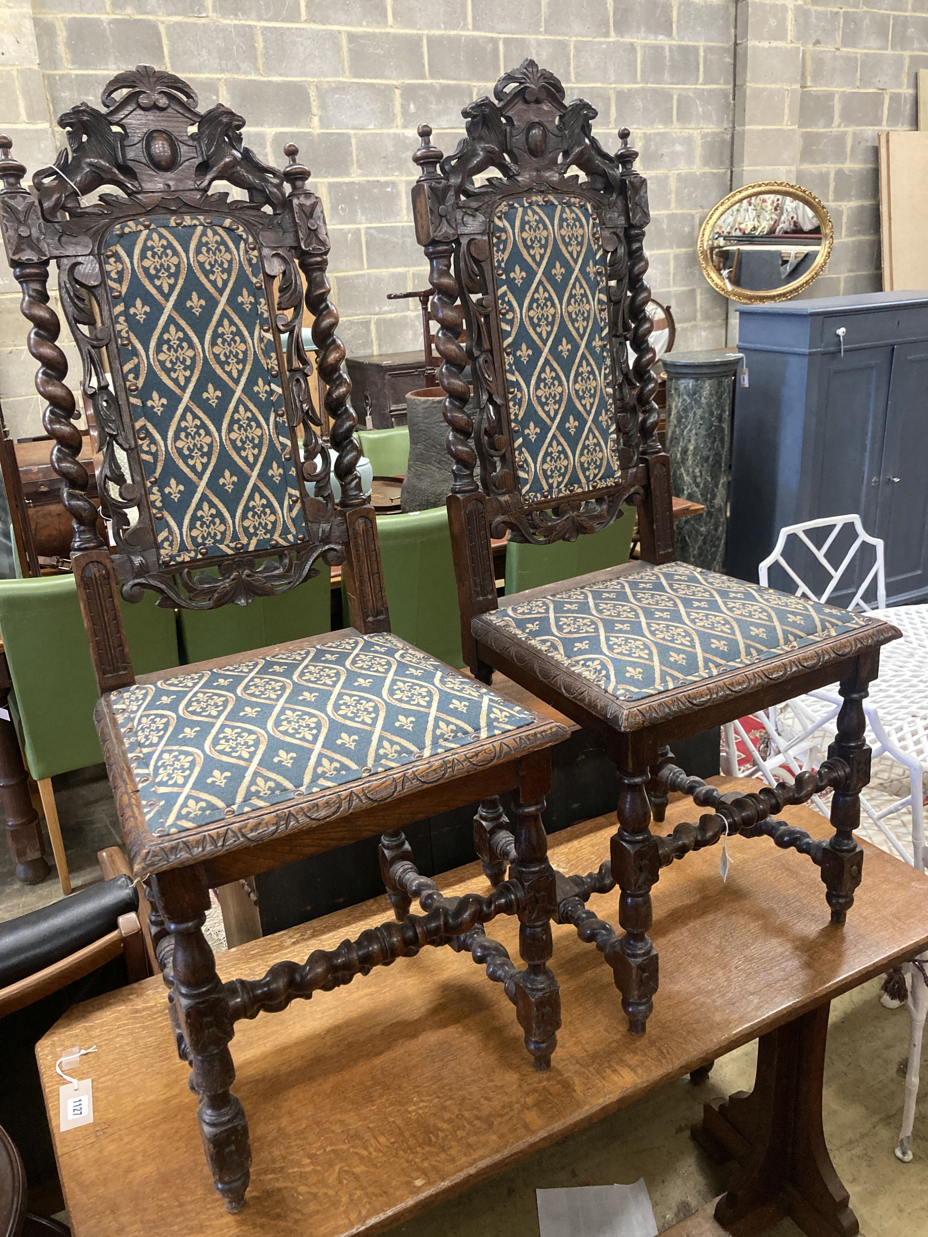 A pair of late 19th century Flemish carved oak panel backed dining chairs